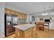 Well-equipped kitchen features a center island, stainless steel refrigerator, and hardwood flooring at 302 Wickley Way, Woodstock, GA 30188