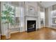Living room with fireplace, marble hearth, neutral walls, and bamboo plant at 302 Wickley Way, Woodstock, GA 30188
