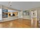 Open living room with hardwood floors flowing into the kitchen and dining areas at 302 Wickley Way, Woodstock, GA 30188
