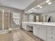 Luxurious main bathroom showcasing dual vanities, tile flooring, and separate glass shower at 302 Wickley Way, Woodstock, GA 30188