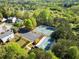 Aerial view of the neighborhood featuring community tennis courts and lush green landscaping at 3978 Oak Crossing Drive Dr, Suwanee, GA 30024