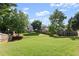 Expansive backyard with lush greenery and mature trees creating a serene and private outdoor space at 3978 Oak Crossing Drive Dr, Suwanee, GA 30024