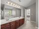 Bathroom featuring double sinks, a large mirror, and tiled floors at 3978 Oak Crossing Drive Dr, Suwanee, GA 30024