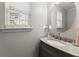 Well-lit bathroom with granite vanity and round mirror at 3978 Oak Crossing Drive Dr, Suwanee, GA 30024