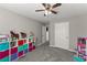 This bright, neutral-toned bedroom has tons of toy storage at 3978 Oak Crossing Drive Dr, Suwanee, GA 30024