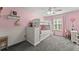 Charming bedroom featuring a white bunk bed, pink walls, and ample natural light from the window at 3978 Oak Crossing Drive Dr, Suwanee, GA 30024