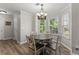 Cozy dining area featuring a round table, chandelier lighting, and natural light from large windows at 3978 Oak Crossing Drive Dr, Suwanee, GA 30024