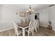 Dining room with a modern chandelier, elegant table set, and updated floors that complement the neutral walls at 3978 Oak Crossing Drive Dr, Suwanee, GA 30024