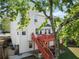 Exterior view of the home featuring a well-maintained yard, deck, and mature trees at 3978 Oak Crossing Drive Dr, Suwanee, GA 30024