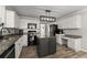 Contemporary kitchen boasts stainless steel appliances, granite countertops, a center island, and custom cabinetry at 3978 Oak Crossing Drive Dr, Suwanee, GA 30024