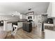 Bright kitchen featuring white cabinetry, granite countertops, black stainless appliances, and a center island at 3978 Oak Crossing Drive Dr, Suwanee, GA 30024