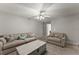 Inviting living room with plush sofas, a ceiling fan, and a stylish coffee table at 3978 Oak Crossing Drive Dr, Suwanee, GA 30024