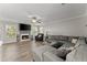 Spacious living room featuring a fireplace, hardwood floors, and a comfortable sectional couch, perfect for relaxation at 3978 Oak Crossing Drive Dr, Suwanee, GA 30024