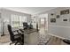 Inviting home office with natural light, a stylish desk setup, and elegant decor that complements the wood flooring at 3978 Oak Crossing Drive Dr, Suwanee, GA 30024
