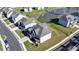 A top-down aerial shot displays the roof and backyard of a modern home near a scenic pond at 4409 Encore Park Lane, Duluth, GA 30097