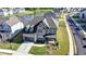 Stunning aerial view of a brick house, showcasing the lush landscaping, pond, and the well-manicured lawn at 4409 Encore Park Lane, Duluth, GA 30097