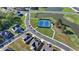 Enjoy an aerial view of a residential neighborhood, complete with a serene pond and a meticulously maintained tennis court at 4409 Encore Park Lane, Duluth, GA 30097