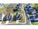 Stunning aerial view of modern homes with manicured lawns and a tranquil pond at 4409 Encore Park Lane, Duluth, GA 30097