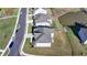 A top-down aerial shot displays the roof and backyard of a modern home near a scenic pond at 4409 Encore Park Lane, Duluth, GA 30097