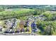 An aerial view shows a home with an outlined property near ponds, green spaces, and other homes at 4409 Encore Park Lane, Duluth, GA 30097