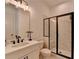 Modern bathroom features a sleek vanity, walk-in shower with glass doors, and elegant fixtures at 4409 Encore Park Lane, Duluth, GA 30097