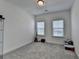 Minimalist bedroom with neutral carpeting, ample natural light, and versatile space for various uses at 4409 Encore Park Lane, Duluth, GA 30097