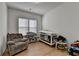 Cozy Bedroom with a comfortable armchair, changing table, and crib by the window at 4409 Encore Park Lane, Duluth, GA 30097