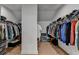 Spacious walk-in closet featuring custom shelving and ample storage space for an organized wardrobe at 4409 Encore Park Lane, Duluth, GA 30097