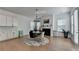 Bright dining area features hardwood floors, a modern chandelier, and a cozy fireplace, creating a welcoming ambiance at 4409 Encore Park Lane, Duluth, GA 30097