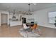 Dining area features a round table, chairs, and open floor plan with modern kitchen accents at 4409 Encore Park Lane, Duluth, GA 30097