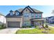 Beautiful two-story brick home featuring a two-car garage, a covered front porch, and manicured landscaping at 4409 Encore Park Lane, Duluth, GA 30097