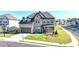 Attractive two-story brick home featuring a two-car garage, a covered front porch, and a well-maintained lawn at 4409 Encore Park Lane, Duluth, GA 30097