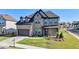 Desirable two-story brick home featuring a two-car garage, a covered front porch, and a lush, green lawn at 4409 Encore Park Lane, Duluth, GA 30097