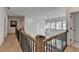 Hallway showcasing wood floors, iron railing, and a view of the living area, highlighting the home's design at 4409 Encore Park Lane, Duluth, GA 30097