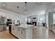 Open-concept kitchen with modern appliances, island seating, and seamless flow into the dining and living areas at 4409 Encore Park Lane, Duluth, GA 30097