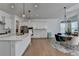 Open kitchen with a central island, stainless steel appliances, and a seamless flow to the dining area at 4409 Encore Park Lane, Duluth, GA 30097