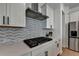 Close-up of a modern kitchen featuring a gas cooktop and sleek cabinetry at 4409 Encore Park Lane, Duluth, GA 30097
