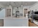 Elegant kitchen boasts a spacious island, stainless steel appliances, and stylish backsplash at 4409 Encore Park Lane, Duluth, GA 30097