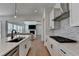 Stylish kitchen island featuring stainless steel appliances, modern fixtures, and an open view to the living area at 4409 Encore Park Lane, Duluth, GA 30097