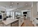 Modern kitchen island offers seating and views to dining and living spaces with contemporary decor at 4409 Encore Park Lane, Duluth, GA 30097