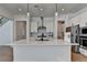 Modern kitchen features a large island, stainless steel appliances, and contemporary lighting fixtures at 4409 Encore Park Lane, Duluth, GA 30097