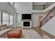Comfortable living room with a fireplace, plush sofa, and large windows at 4409 Encore Park Lane, Duluth, GA 30097