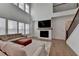 Spacious living room with fireplace, hardwood floors, and a sectional sofa at 4409 Encore Park Lane, Duluth, GA 30097