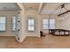 Open-concept room with gorgeous hardwood floors, bright lighting, and access to the front entry at 4409 Encore Park Lane, Duluth, GA 30097