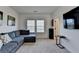 Cozy living room with a plush sectional sofa, large TV, and ample natural light, great for relaxation at 4409 Encore Park Lane, Duluth, GA 30097