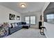 Cozy living room with a plush sectional sofa, large TV, and ample natural light, great for relaxation at 4409 Encore Park Lane, Duluth, GA 30097
