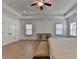A bright main bedroom shows hardwood floors, a ceiling fan, recessed lights, and two sunny windows at 4409 Encore Park Lane, Duluth, GA 30097