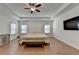 A bright main bedroom shows hardwood floors, a ceiling fan, recessed lights, and two sunny windows at 4409 Encore Park Lane, Duluth, GA 30097