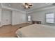 A large main bedroom features hardwood floors, recessed lighting, a ceiling fan, and dual closets at 4409 Encore Park Lane, Duluth, GA 30097