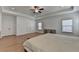 A large main bedroom features hardwood floors, recessed lighting, a ceiling fan, and dual closets at 4409 Encore Park Lane, Duluth, GA 30097